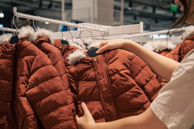 Free photo children's jackets on hangers in a clothing store