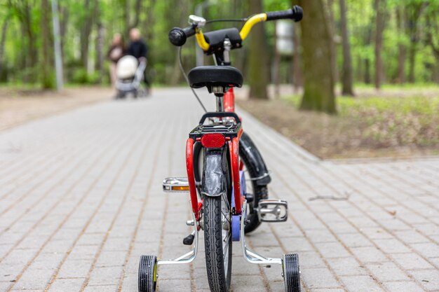 Children's tricycle in the park on a blurred background