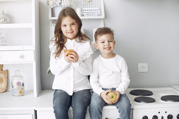 Children sitting in a kitchen at home