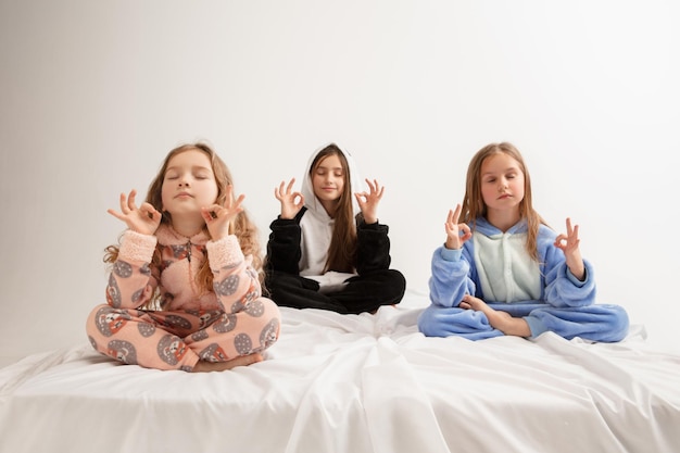 Children in soft warm pajamas having party colored bright playing at home