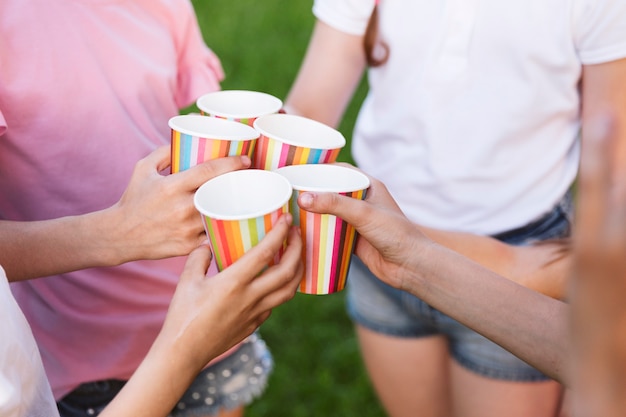 Free photo children toasting with colorful cups