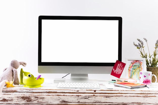 Children toys on workplace with computer