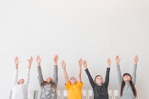 Children with their hands up