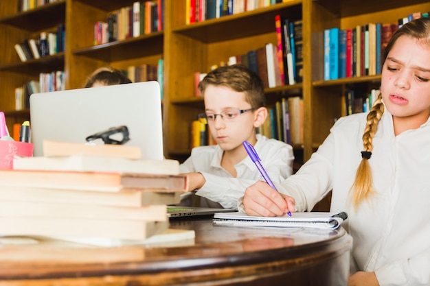 Children working hard on home assignment 