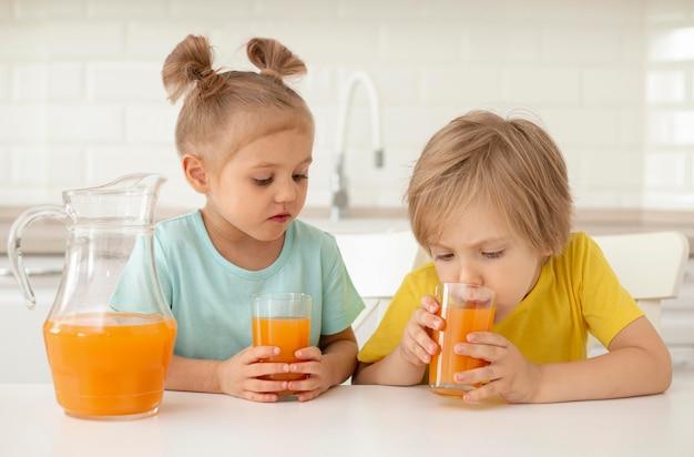 Childrens drinking juice