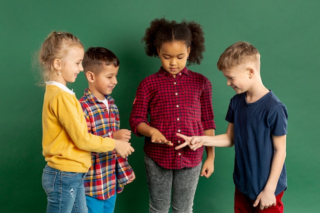 Free photo childrens playing rock scissors paper game