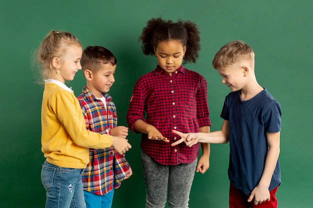 Childrens playing rock scissors paper game