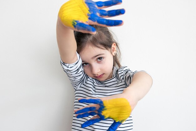 Childs hands painted on ukraine flag colors