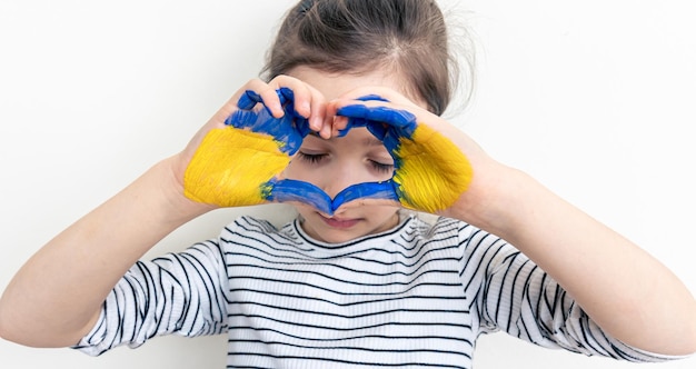 Childs hands painted on ukraine flag colors