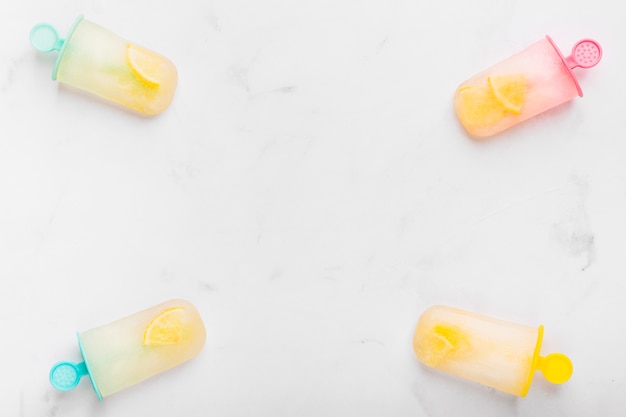 Chilled juicy ice popsicle with citrus on colorful sticks