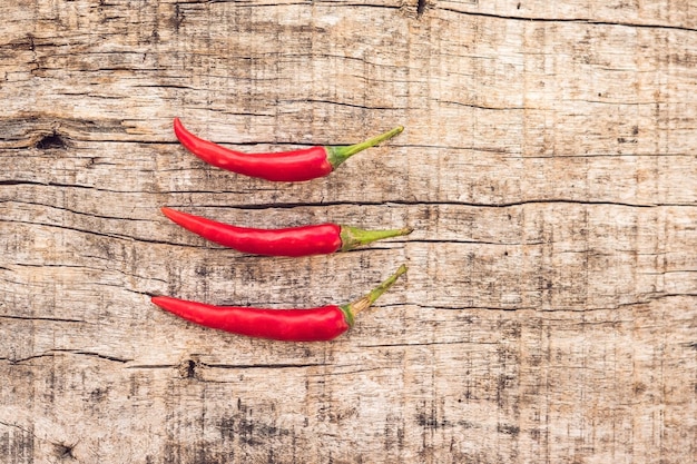 A chilli pepper on old wooden surface.