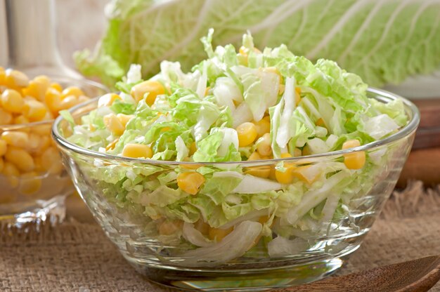 Chinese cabbage salad with sweet corn in a glass bowl