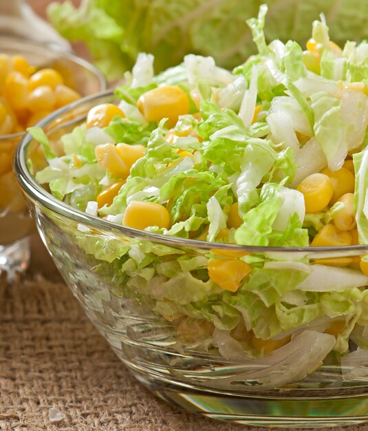 Chinese cabbage salad with sweet corn in a glass bowl