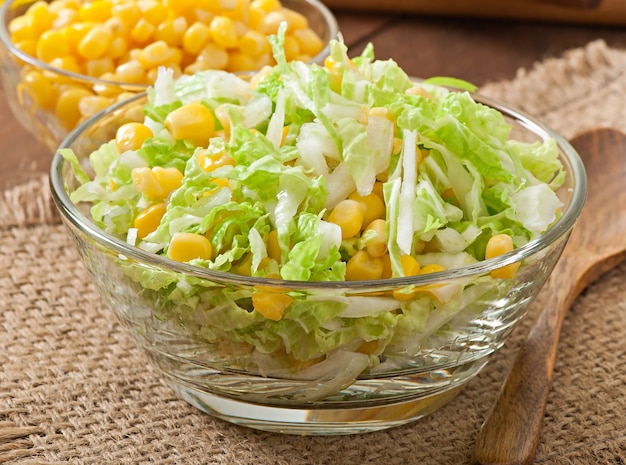 Chinese cabbage salad with sweet corn in a glass bowl