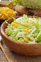 Free photo chinese cabbage salad with sweet corn in a wooden bowl