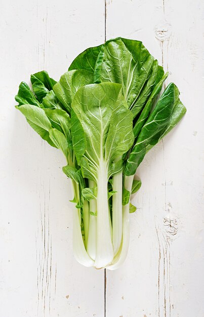 Chinese cabbage on white wooden table.