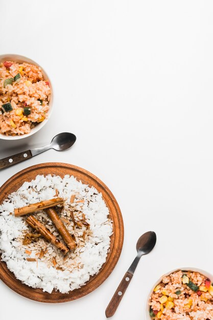 Chinese fried and steam rice with cinnamon sticks on white background