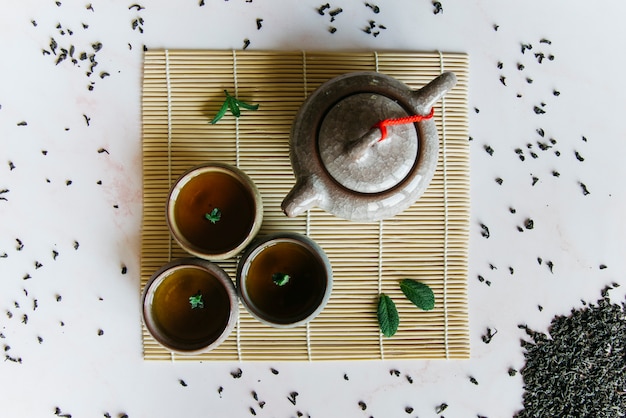 Chinese or japanese traditional teapot; cup of tea on placemat