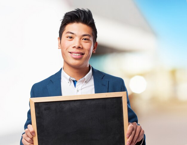 chinese man holding chalkboard