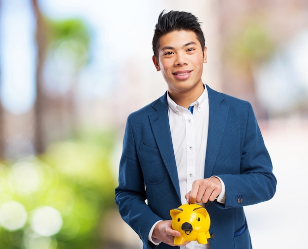 chinese man holding piggy bank