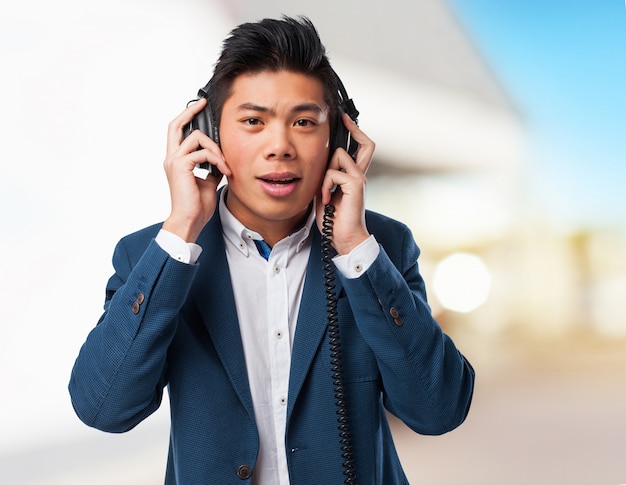 Free photo chinese man listening music