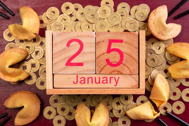 Chinese new year date with fortune cookies and coins