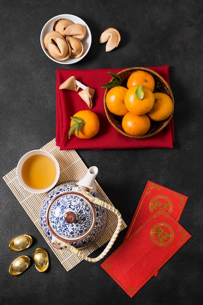 Chinese new year with tea pot and mandarines