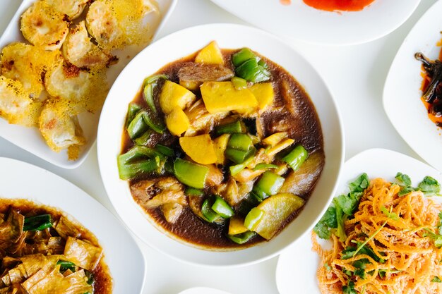  chinese soup with meat vegetables and green pepper in plate