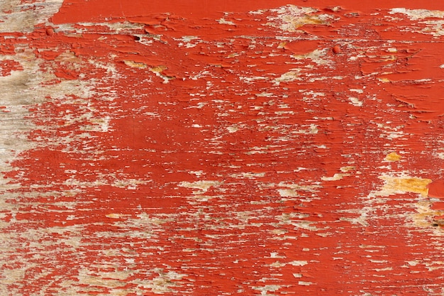 Chipping paint on aged wooden surface