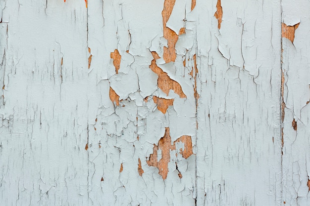 Chipping paint on worn wooden surface
