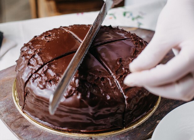 choco cake getting sliced yummy delicious round whole designing with kumquats nuts