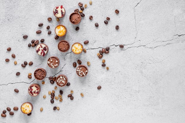 Chocolate assortment on light background with copy space