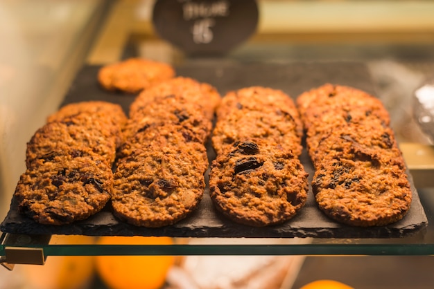 Chocolate baked oats cookies on rock tray in the display cabinet