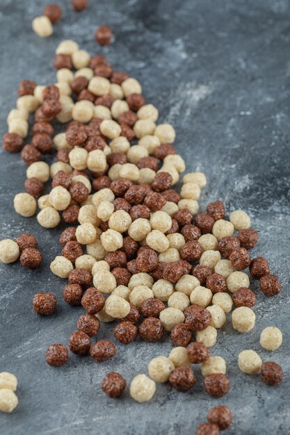 Chocolate balls corn flakes isolated on gray.