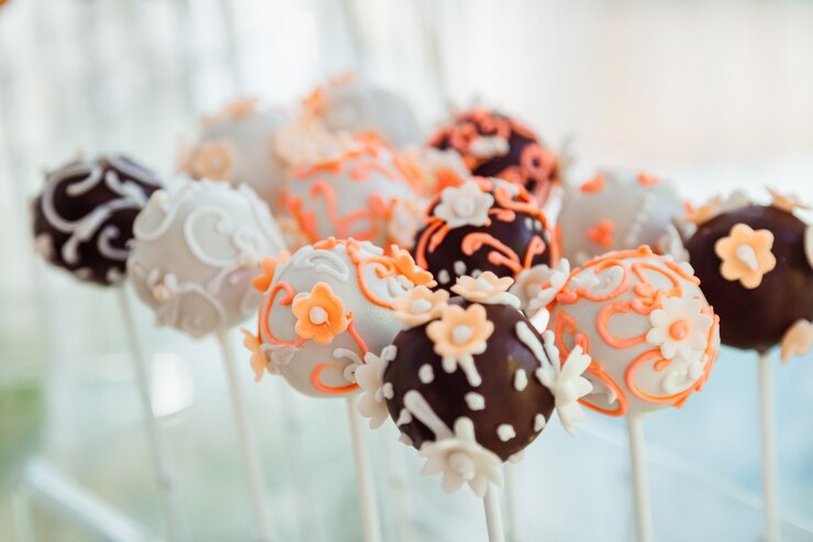 Free Photo chocolate balls with glaze flowers put on white sticks 