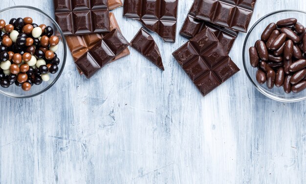 Chocolate bars with candies in glass bowls