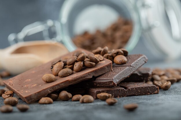 Chocolate bars with chocolate chips on gray.