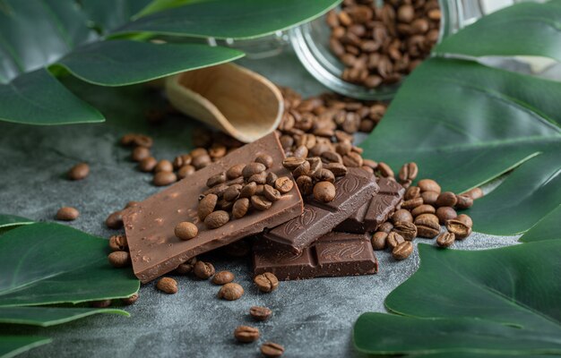 Chocolate bars with chocolate chips on gray.