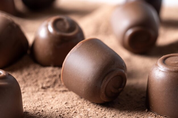 Chocolate bonbons and cocoa powder background Close up