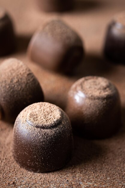 Chocolate bonbons and cocoa powder background