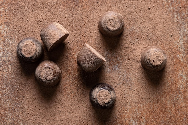 Chocolate bonbons and cocoa powder background