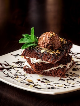 Chocolate brownie cake with a scoop of ice cream.