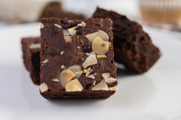 Chocolate brownies on a white plate.