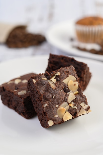 Chocolate brownies on a white plate.