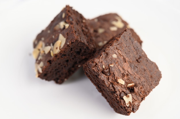 Chocolate brownies on a white plate.