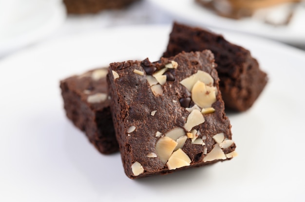 Chocolate brownies on a white plate.