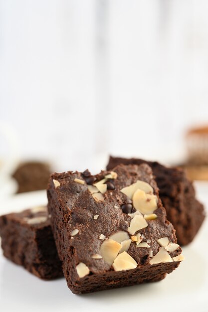 Chocolate brownies on a white plate.