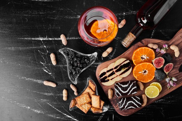 Chocolate brownies with seasonal fruits and a glass of wine.