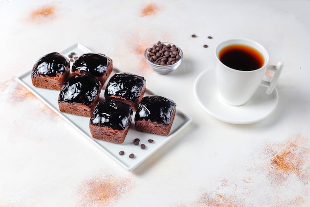 Chocolate cake bites with chocolate sauce and with fruits.