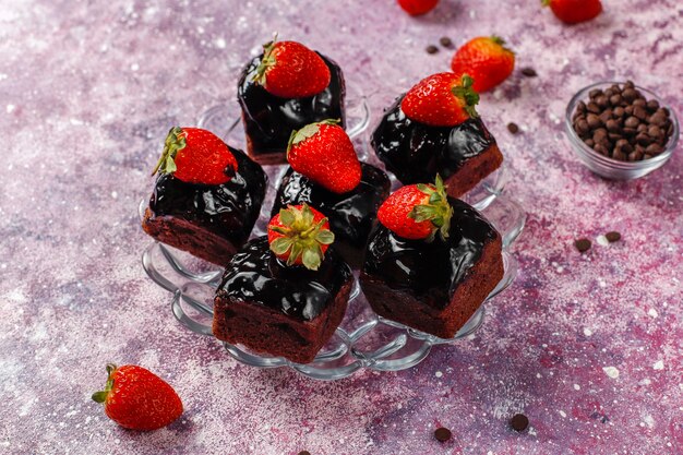 Chocolate cake bites with chocolate sauce and with fruits.